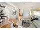 A bright living room showcasing hardwood floors and minimalist decor, open to dining area at 2680 S Garfield Cir, Denver, CO 80210