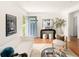 Bright living room featuring hardwood floors, modern furnishings, and a stylish entry door at 2680 S Garfield Cir, Denver, CO 80210