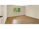 Bedroom featuring wood floors, a large window and closet at 7755 E Quincy Ave # 206, Denver, CO 80237