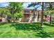 Exterior view of the home featuring a well-manicured lawn and balconies at 7755 E Quincy Ave # 206, Denver, CO 80237