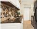 Kitchen with stylish backsplash, granite counters and white cabinets at 7755 E Quincy Ave # 206, Denver, CO 80237
