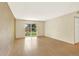 Living room featuring wood floors and a sliding door to the balcony at 7755 E Quincy Ave # 206, Denver, CO 80237