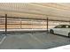 Covered parking space with clearly marked parking spots, offering protection from the elements at 7755 E Quincy Ave # 206, Denver, CO 80237