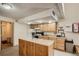 Shared kitchen with wood cabinets and island at 7455 E Quincy Ave # 204, Denver, CO 80237