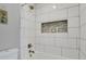 Clean bathroom with a white tiled shower and niche at 3550 S Harlan # 144, Denver, CO 80235