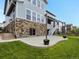Backyard featuring a patio, string lights, brick accents, and landscaping at 22263 Boundstone St, Parker, CO 80138