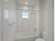 This bright bathroom features a shower with tub, white tiles, and chrome fixtures at 22263 Boundstone St, Parker, CO 80138