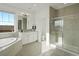 Bright bathroom features a tub, large shower with seat, double vanity, and tile flooring at 22263 Boundstone St, Parker, CO 80138
