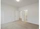 Clean bedroom with carpet flooring and closet, leading to a full bathroom and additional rooms at 22263 Boundstone St, Parker, CO 80138