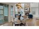 Elegant dining room with a stone fireplace, hardwood floors, and lots of natural light at 22263 Boundstone St, Parker, CO 80138