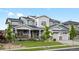 Charming two-story house showcasing impeccable landscaping, stone details, and a spacious three-car garage at 22263 Boundstone St, Parker, CO 80138