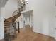 Open foyer featuring hardwood floors, a curved staircase, and plenty of natural light from the nearby windows at 22263 Boundstone St, Parker, CO 80138