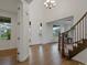 Grand foyer with hardwood floors, a stunning chandelier, and a staircase that leads to the upper level at 22263 Boundstone St, Parker, CO 80138