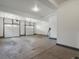 Attached two-car garage with three garage doors, overhead lighting, and EV charger at 22263 Boundstone St, Parker, CO 80138