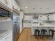 Modern kitchen with stainless steel appliances, an island with seating, and hardwood floors at 22263 Boundstone St, Parker, CO 80138