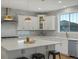 Bright kitchen with a large island, stone backsplash, and stainless steel appliances at 22263 Boundstone St, Parker, CO 80138