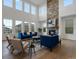Bright, open living room with fireplace, hardwood floors, and tall windows that let in natural light at 22263 Boundstone St, Parker, CO 80138