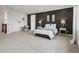 This stylish main bedroom features an accent wall, an area rug, and a large window at 22263 Boundstone St, Parker, CO 80138