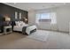 The light-filled main bedroom offers an accent wall, carpet floor, and large windows with natural light at 22263 Boundstone St, Parker, CO 80138