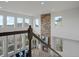 From the staircase looking at the living room fireplace, high ceilings and large windows at 22263 Boundstone St, Parker, CO 80138