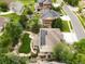 Aerial view of a large lot, green lawn, patio, and solar panels on roof at 15348 W 75Th Pl, Arvada, CO 80007