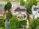 Aerial view of the home featuring a backyard oasis, solar panels, and mature trees at 15348 W 75Th Pl, Arvada, CO 80007