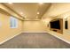 Finished basement rec room with recessed lighting, carpet, and a flat screen TV at 15348 W 75Th Pl, Arvada, CO 80007