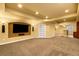 Finished basement rec room with flat screen TV and a bar area at 15348 W 75Th Pl, Arvada, CO 80007