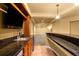 Finished basement bar with granite counters, kitchenette, and sink at 15348 W 75Th Pl, Arvada, CO 80007