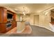 Finished basement featuring bar with granite counters, kitchenette, and tile flooring at 15348 W 75Th Pl, Arvada, CO 80007