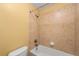 Bathroom featuring tiled shower and bathtub with neutral finishes at 15348 W 75Th Pl, Arvada, CO 80007
