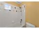Bathroom featuring tiled bathtub with colorful decorative tiling at 15348 W 75Th Pl, Arvada, CO 80007