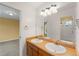 Bathroom showcasing a double sink vanity and large mirror with views of the home interior at 15348 W 75Th Pl, Arvada, CO 80007