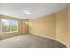 Spacious bedroom with carpet and a large window at 15348 W 75Th Pl, Arvada, CO 80007