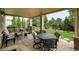 Covered patio with outdoor seating, dining area, and grill, perfect for entertaining at 15348 W 75Th Pl, Arvada, CO 80007