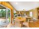 Bright dining area with modern table, sliding door access to the outdoors, and inviting fireplace at 15348 W 75Th Pl, Arvada, CO 80007
