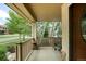 Relaxing front porch with views of the neighborhood and a comfortable seating area at 15348 W 75Th Pl, Arvada, CO 80007
