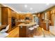 Spacious kitchen boasts a center island, stainless steel appliances, and ample cabinet space at 15348 W 75Th Pl, Arvada, CO 80007
