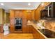 Gourmet kitchen with custom cabinets, granite countertops, and top-of-the-line appliances at 15348 W 75Th Pl, Arvada, CO 80007