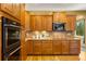 Well-equipped kitchen featuring custom wood cabinets, stainless steel appliances, and decorative tile backsplash at 15348 W 75Th Pl, Arvada, CO 80007