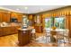 Eat-in kitchen with modern appliances, wooden cabinets, island with barstool seating, and natural light at 15348 W 75Th Pl, Arvada, CO 80007