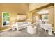Comfortable living room space with large windows and open floor plan at 15348 W 75Th Pl, Arvada, CO 80007