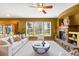 Spacious living room with a fireplace, large windows, and comfortable sofa, offering natural light at 15348 W 75Th Pl, Arvada, CO 80007