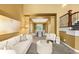 Bright living room featuring high ceilings, elegant furnishings, and seamless flow to dining area at 15348 W 75Th Pl, Arvada, CO 80007