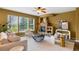 Cozy living room with stone fireplace, bright windows, comfortable seating, and stylish decor at 15348 W 75Th Pl, Arvada, CO 80007