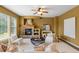 Inviting living room with a stone fireplace, bright windows, neutral furniture, and modern decor at 15348 W 75Th Pl, Arvada, CO 80007