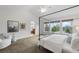 Bright main bedroom with a canopy bed, sitting area, and an abundance of natural light from large windows at 15348 W 75Th Pl, Arvada, CO 80007