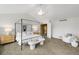 Bright bedroom featuring a canopy bed, soft natural light, and contemporary decor at 15348 W 75Th Pl, Arvada, CO 80007