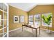Well-lit home office with vaulted ceiling, ample natural light, and a functional workspace at 15348 W 75Th Pl, Arvada, CO 80007