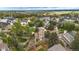 Panoramic aerial view of a residential community with lush green trees and well-maintained houses in a peaceful neighborhood at 613 N Brentwood Ct, Castle Rock, CO 80104